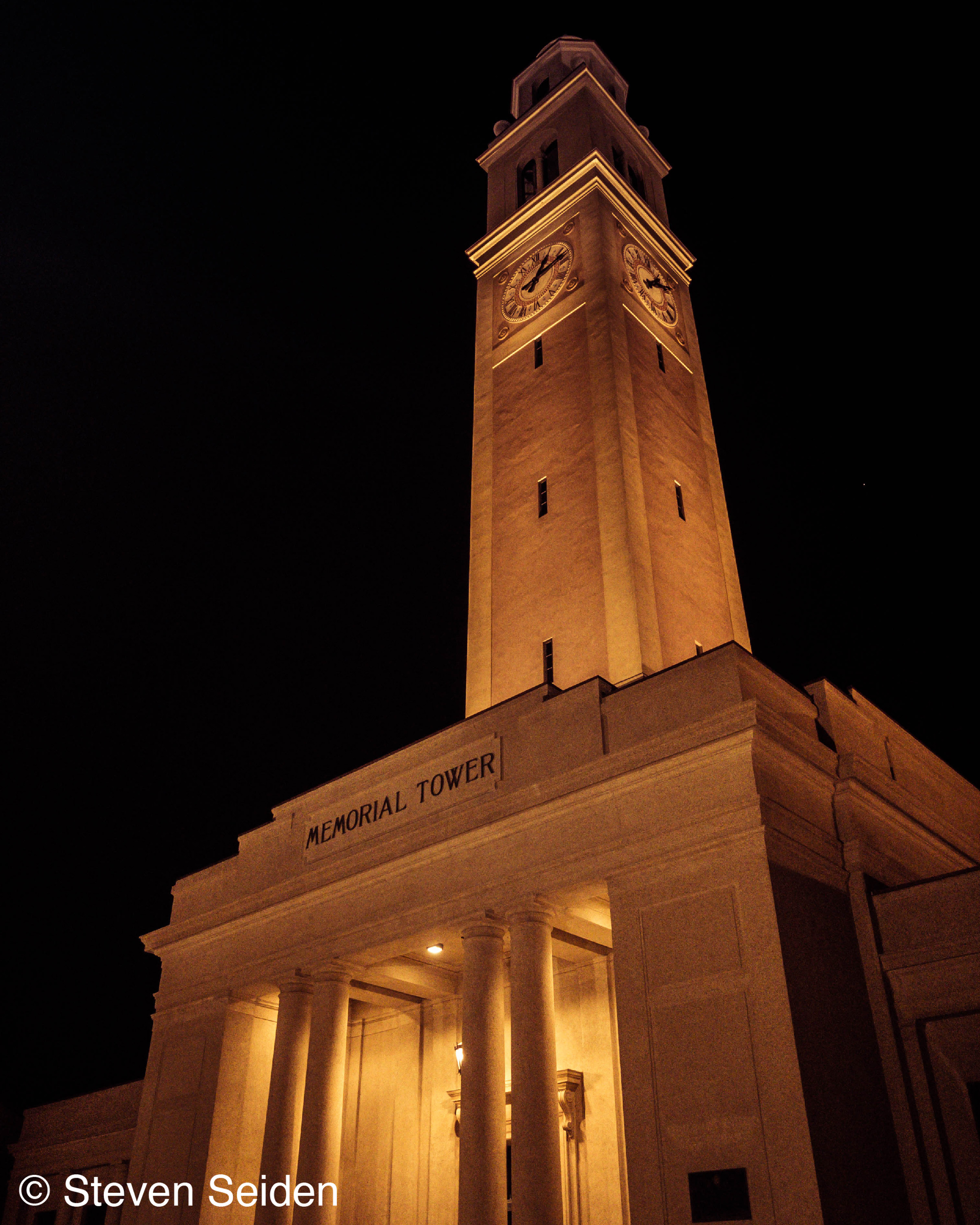 A picture of a clock tower at night.